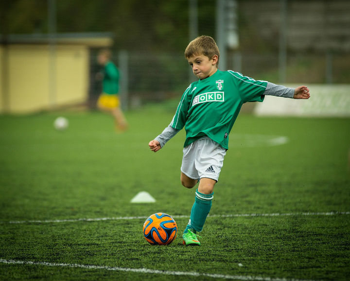 soccer boy shooting a ball