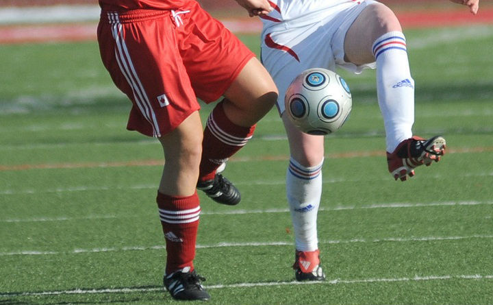 soccer players in red and white during soccer game