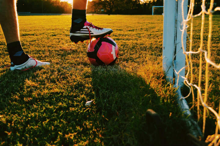 soccer shoes and ball on the field