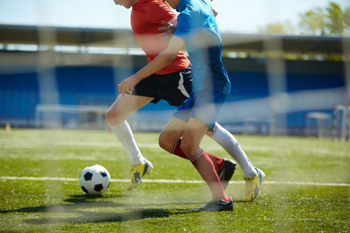 girl soccer tackle