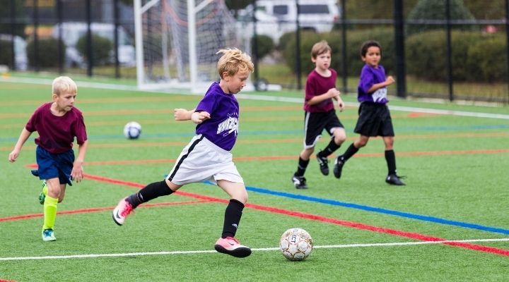 Boys playing soccer at the field