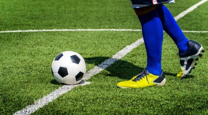 A soccer player preparing for a kick-off