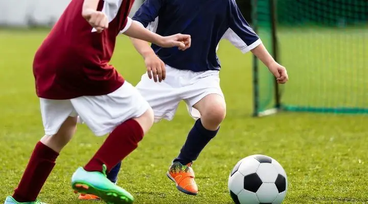Two young athletes playing to take possession of the soccer ball