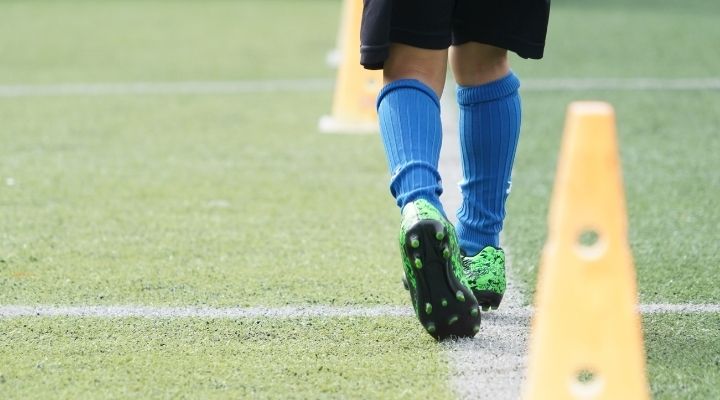 Soccer player practicing the maradona soccer move with cones