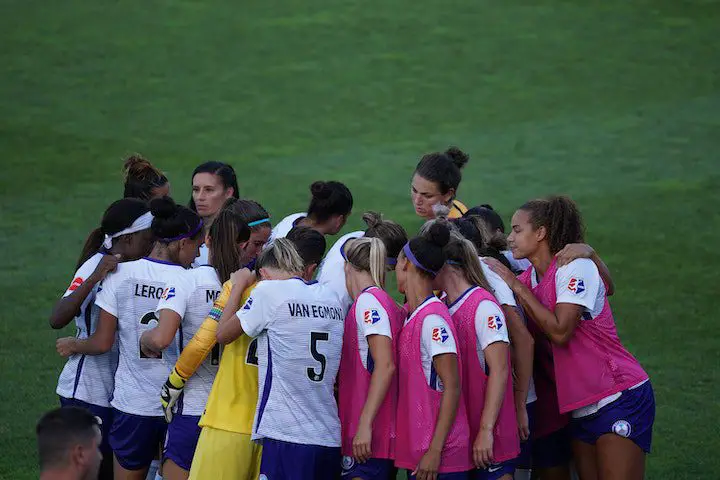 female soccer team in a huddle
