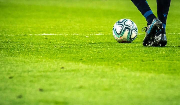 soccer-cleats soccer-player-in-black-cleats-letting-a-soccer-ball-roll