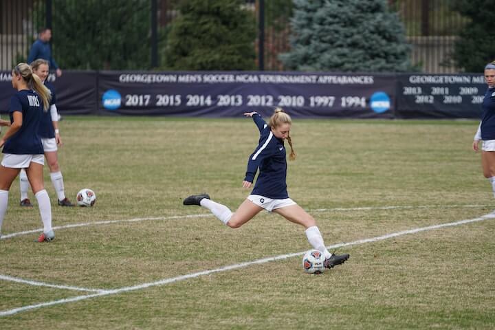 soccer-cleats female-soccer-player-in-training-about-to-kick-the-ball