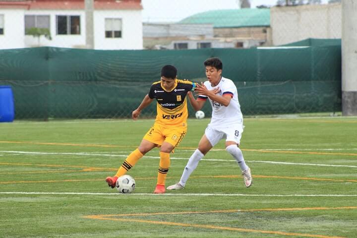 two-soccer-players-making-contact-to-get-possession-of-the-ball