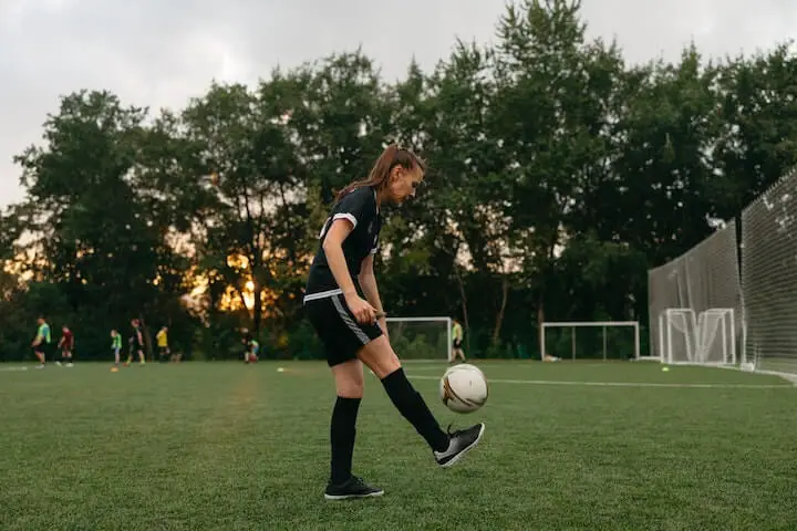 female-soccer-player-practices-dribbling-drills