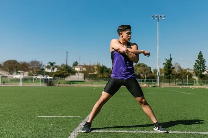 soccer-player-stretches-before-training