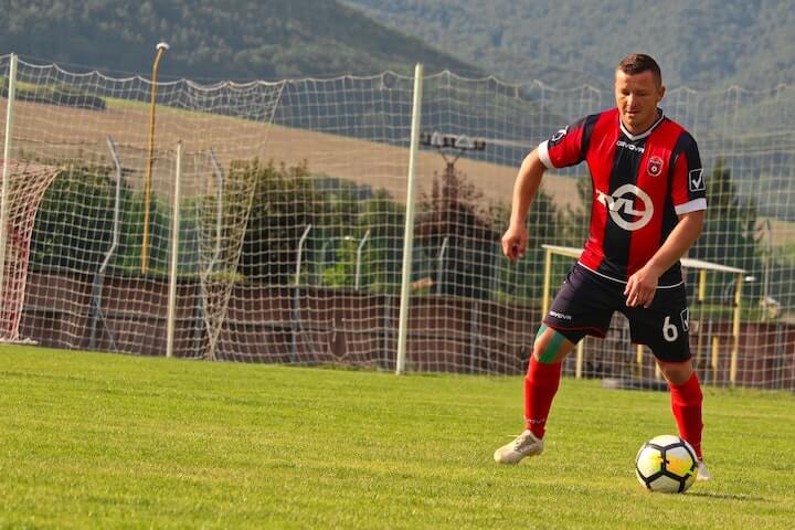 the-number-6-in-soccer-team-pushes-the-ball-during-a-match