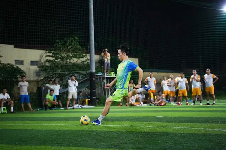 soccer player takes penalty kick during a match
