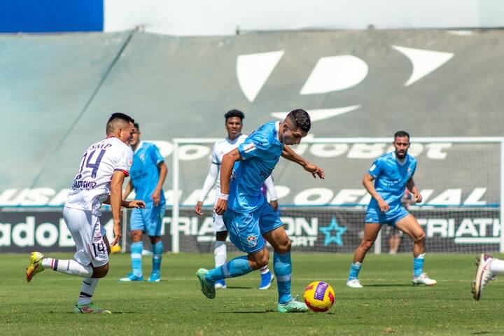 player-number-8-in-soccer-looks-to-beat-defenders-during-a-match