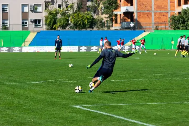 goalkeeper kicks the ball during soccer practice