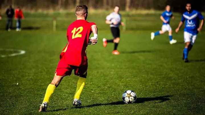 youth soccer player about to pass the ball during a match