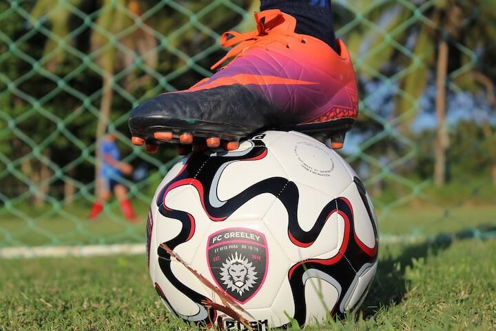 player showing his soccer cleats