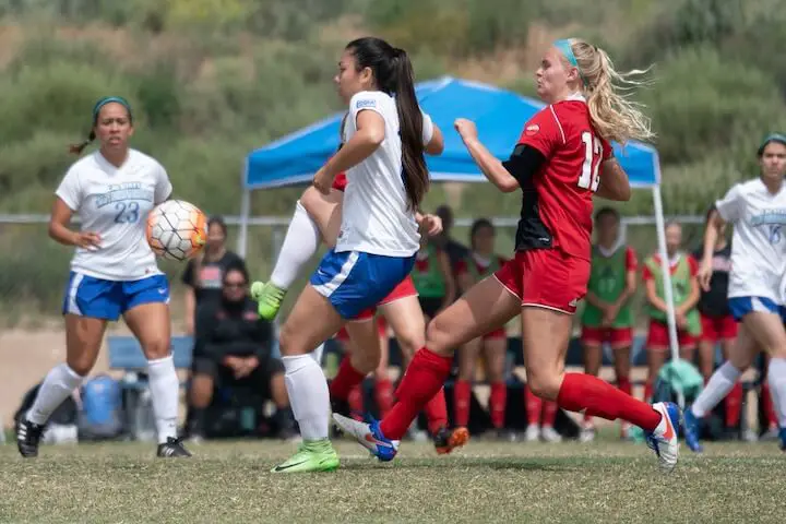 female soccer players fight for the ball during a match