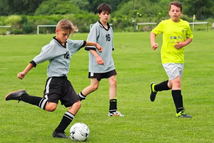 Youth soccer player looks to score in a 3-4-1-2 formation in soccer