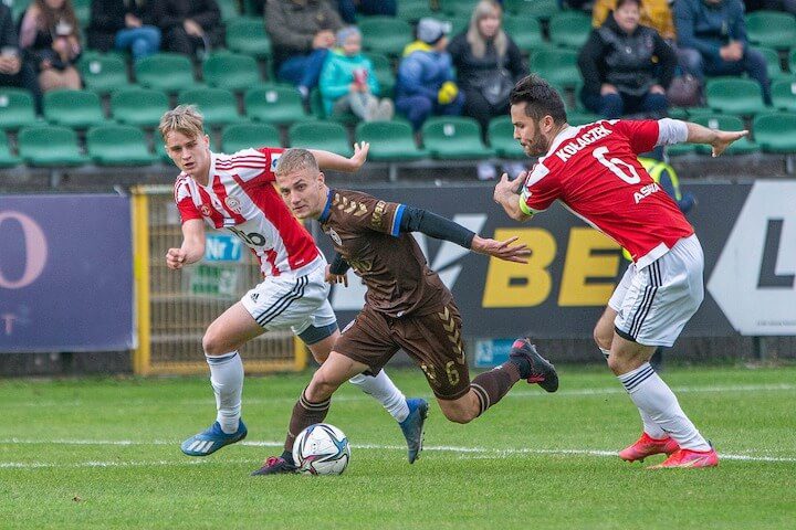 soccer player looks to get past a defender during a match